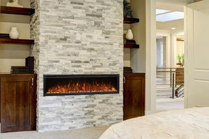 Wall-mounted electric fireplace installed in a finished bedroom