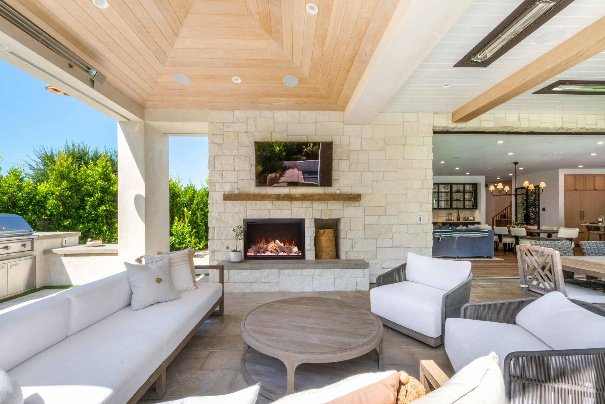 Amantii Traditional Bespoke electric fireplace with split logs in an outdoor installation